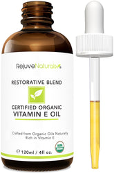 RejuveNaturals Vitamin E Oil bottle on a vanity for daily skin nourishment and hydration.