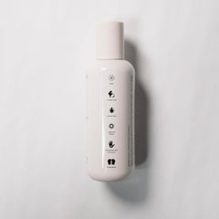 REVERIE Natural Balancing Shampoo lather on hand for gentle cleansing and hydration.