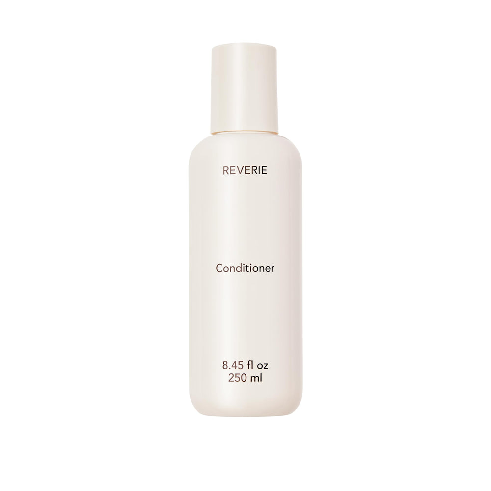 REVERIE natural nourishing conditioner bottle shows color-safe hydration for glossy, manageable hair.