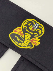 Ripple Junction Cobra Kai headband tie-back closure detail for adjustable fit and comfort