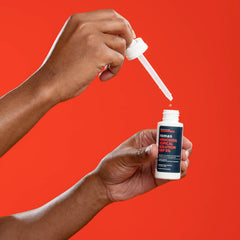 Roman Minoxidil being applied to thinning scalp area for targeted results