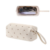 RSRSLEII large quilted hair tools travel bag in beige with bow, ideal for organizing gear.