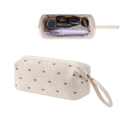 RSRSLEII large quilted hair tools travel bag in beige with bow, ideal for organizing gear.