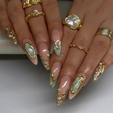 RUOKEXIN almond nails with gold glitter designs for a glam party look.