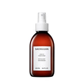 SACHAJUAN Leave-In Conditioner bottle close-up; lightweight, oil-free formula for shine.