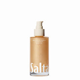 Saltair Shimmering Body Oil bottle pour shows sun-kissed glow for all skin types.