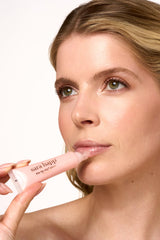 Sara Happ The Lip Slip One Luxe Gloss packaging flatlay with premium branding