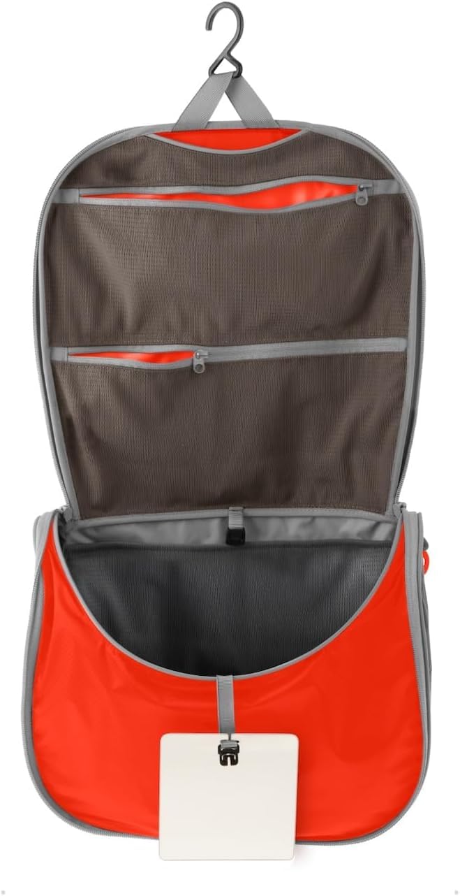 Sea to Summit small hanging toiletry bag in spicy orange offers compact, organized storage for minimalist travel.