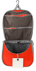 Sea to Summit small hanging toiletry bag in spicy orange offers compact, organized storage for minimalist travel.