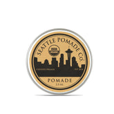 Seattle Pomade Co. organic pomade bottle being poured for balanced hold and shine.