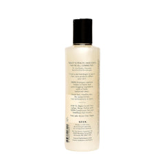 SEEN conditioner bottle front with detangling and frizz control promise