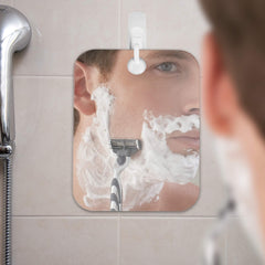 Shave Well Deluxe fogless mirror shown handheld option for flexible grooming.