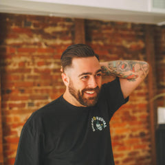 Shear Revival American Gardens clay pomade in hands demonstrating easy application