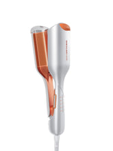 SHEGLAM Beach Babe Waver with two barrels creates voluminous waves for long hair.