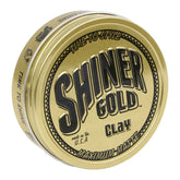 Shiner Gold Clay Pomade bottle closeup showcasing strong hold and matte finish for styling control.