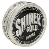 Shiner Gold Pomade bottle pour highlighting strong hold for sleek styles.