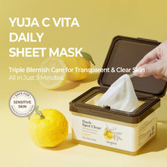 SKINFOOD 1957 Yuja C Vita Daily Sheet Mask on face during application.