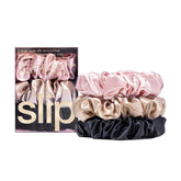 SLIP large scrunchie multi pink closeup: smooth silk reduces friction for gentler hair wear.
