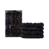 SLIP Silk Skinny Scrunchies Black set of four on flat lay for low-friction hair styling