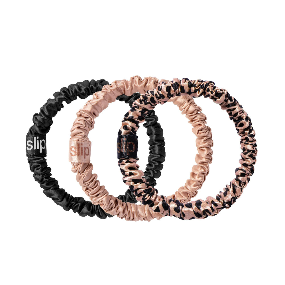 SLIP Skinny Scrunchies in black pure silk offer gentle, crease-free hold for delicate hair.