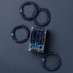 SLIP Skinny Scrunchies Navy worn in a bun with secure, comfortable styling.
