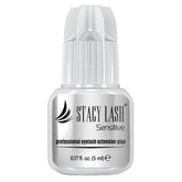 STACY LASH Sensitive adhesive bottle closeup highlighting low fumes for sensitive eyes.