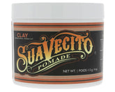 Suavecito Firme Clay pomade application close-up for textured hold.