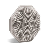 Sud Scrub antimicrobial silicone face scrubber held in hand for precise, gentle cleansing