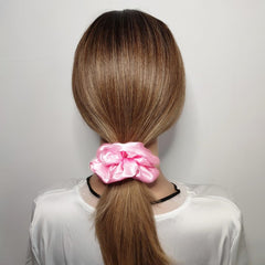 Sufermoe satin silk scrunchie worn on wrist as versatile daily accessory