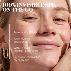Unseen Sunscreen Stick layered over makeup without disruption