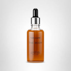 Tan-Luxe The Body Illuminating Self-Tan Drops being mixed with lotion for a tailored shade.