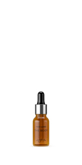 Tan-Luxe The Body Illuminating Drops bottle close-up illustrating vegan self-tanner for natural glow