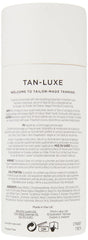 Hand applying Tan-Luxe The Face drops for even, streak-free finish