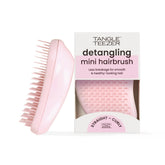 Tangle Teezer original detangler brush palm-size close-up in millennial pink, gentle detangling on knots
