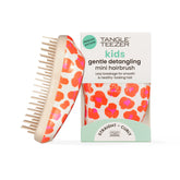 Tangle Teezer Original Detangler mini orange safari held in hand for on-the-go detangling.