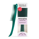 Tangle Teezer Ultimate Detangler Emerald Green gliding through wet hair for gentle detangling.