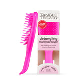 Tangle Teezer Ultimate Detangler Runway Pink hairbrush in hand for quick knot-free styling.