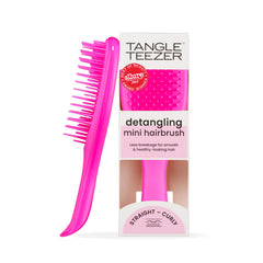 Tangle Teezer Ultimate Detangler Runway Pink hairbrush in hand for quick knot-free styling.