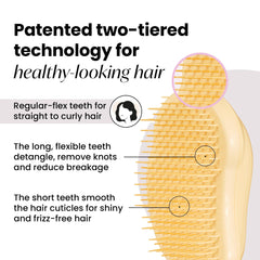 Tangle Teezer Original Detangler Buttercup Yellow in hand showing ergonomic palm grip.