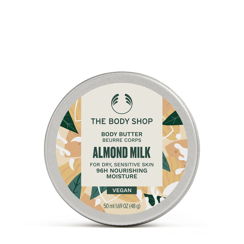 The Body Shop Almond Milk Body Butter packaging closeup showing recyclable materials and vegan commitment.
