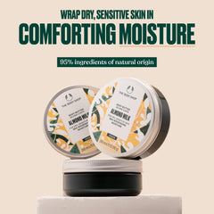 The Body Shop almond milk body butter texture being scooped invites rich hydration.
