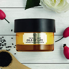 The Body Shop Oils of Life application image demonstrates smooth cream glide.