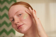 The Body Shop Tea Tree Scrub applying on the face demonstrates gentle cleansing and oil control