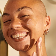 The Body Shop Vitamin E Moisture Cream application shows light massage strokes.