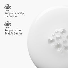 Milky formula applied to the scalp indicating quick absorption and non-greasy feel.