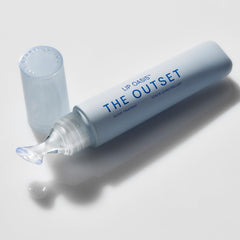 The Outset Lip Oasis Glossy Treatment tube closeup shows smooth applicator and shine