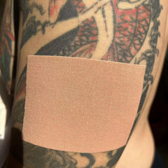 Therasports tattoo cover-up tape on skin demonstrates simple, secure application