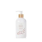 Thymes Hand Lotion Gold Pump bottle close-up, goldleaf detail signaling premium hydration for silky hands.