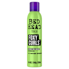 TIGI Bed Head Foxy Curls Mousse bottle front highlighting strong hold and defined curls.