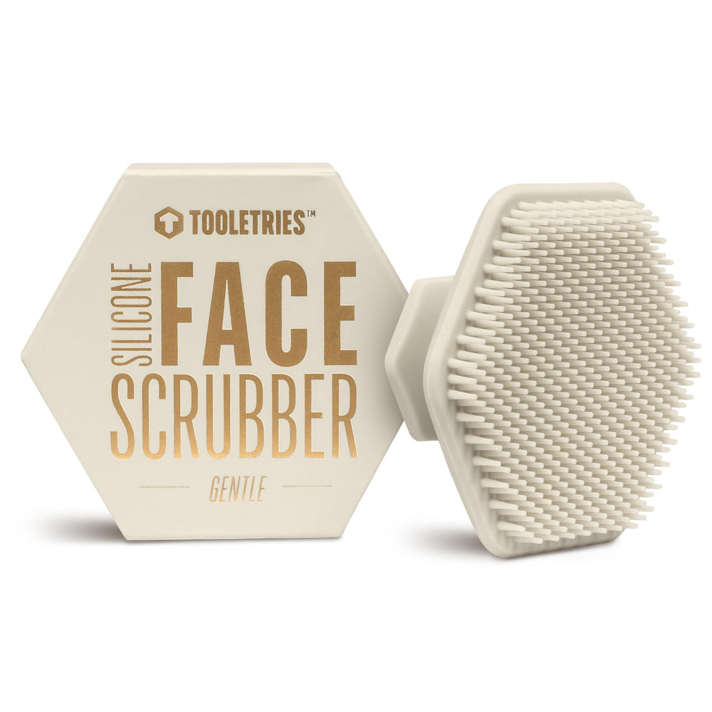 TOOLETRIES Men's Face Scrubber in hand shows silicone bristles for gentle exfoliation.